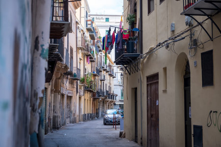 CEFALU, ITALY - SEPTEMBER 29, 2019: Old town street with balconies and clothesのeditorial素材