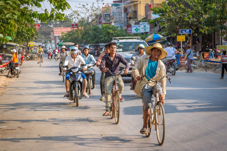 SIEMREAP, CAMBODIA - MARCH 13 2013: The local people drive on the roadのeditorial素材