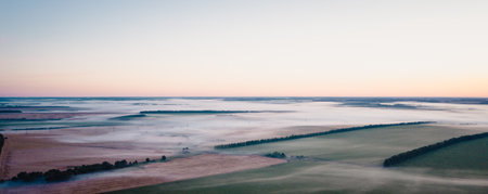 Morning fog in the meadows during sunrise in the countryside, aerial view height of the landscape on...
