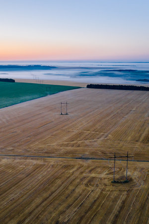 Morning fog in the meadows during sunrise in the countryside, aerial view height of the landscape on...