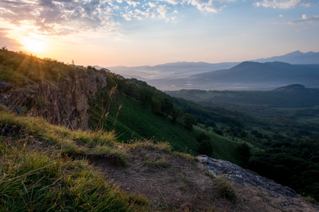 Morning sun and haze in the valley against the background of mountains.の写真素材