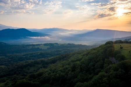 Morning sun and haze in the valley against the background of mountains.の写真素材