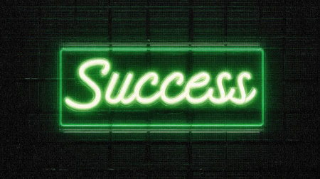 A vibrant neon sign featuring the word "Success" in a stylish script illuminates a dark backdrop, symbolizing motivation and achievement in a modern design.の素材