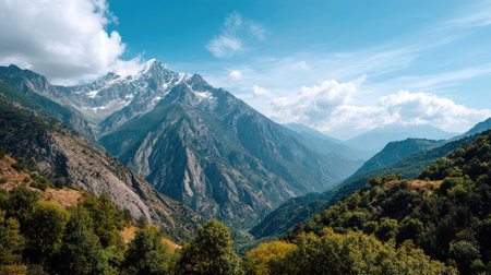 A stunning view of a mountainous landscape featuring snow-capped peaks and vibrant green valleys. Perfect for capturing the essence of nature and adventure.の素材