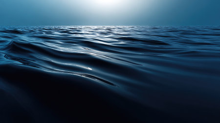 Experience the calm of vast ocean waves under a soft blue sky at sunrise. This serene image captures gentle ripples on the water's surface, evoking tranquility.の素材