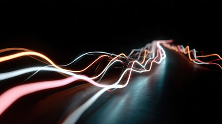 Captivating abstract image featuring long exposure light trails twisting and flowing across a dark background, evoking motion and energy in vibrant colors.の素材