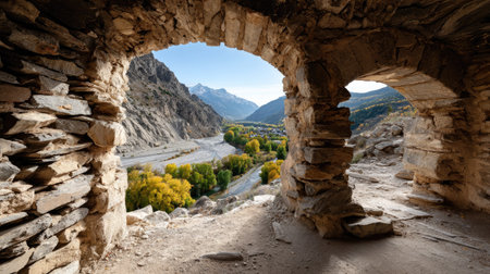 Experience a breathtaking viewpoint framed by ancient stone arches, revealing a stunning autumn landscape with vibrant foliage and majestic mountains.の素材