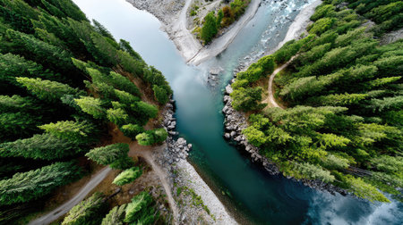 Captivating aerial image showcasing a winding river surrounded by vibrant green forests and rocky outcrops, perfect for nature and travel themes.の素材