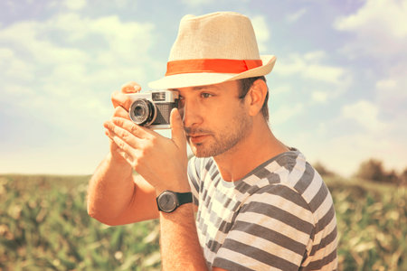 Man taking the photo with the old camera outdoor â vintage styleの写真素材