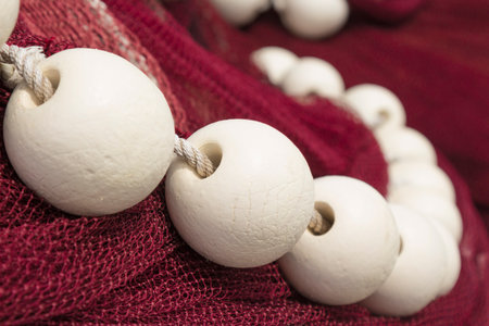 Close-up of white fishing floats on drift net    の写真素材