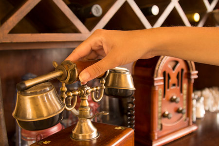 Female hand holding a vintage handset の写真素材
