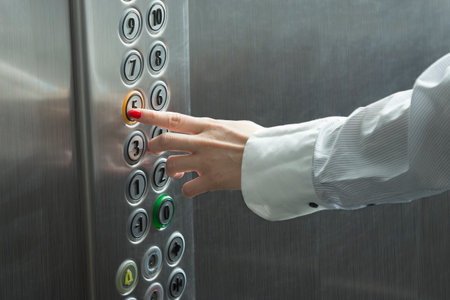 Forefinger pressing the button in the elevator