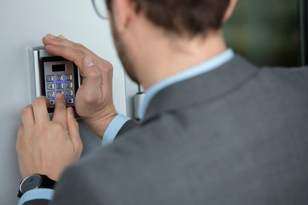 Human hand entering the security code combination to unlock the door   