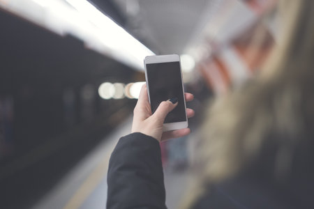 Close up of hand using a blank screen smartphone. Shallow depth of field.の写真素材