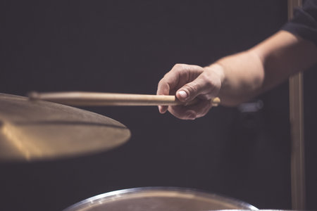 Drummer plays with drumstickの写真素材