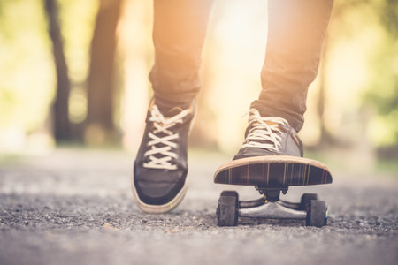 Close up of skateboarder feet while skating in the parkの写真素材