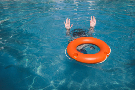 Female and lifebelt in water. Drowning help assistance concepts.