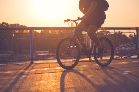 Man cycling at sunset の写真素材