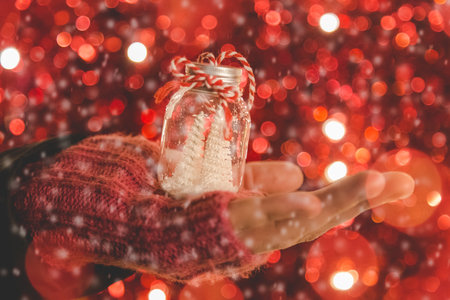 Close up of hand holding christmas ornament outdoors
