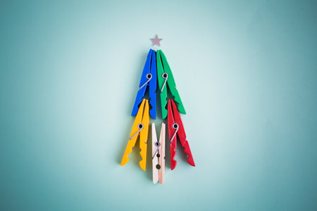 Minimalistic Christmas tree made of colorful clothespins. New Year minimal concept flat layの写真素材