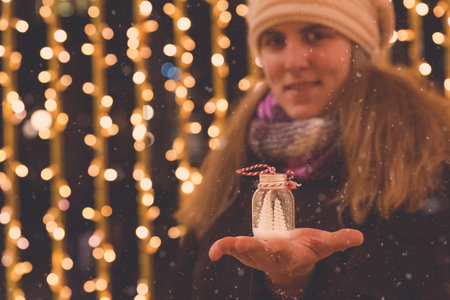 Close up of female holding Christmas tree decoration. People and holidays concept.の写真素材