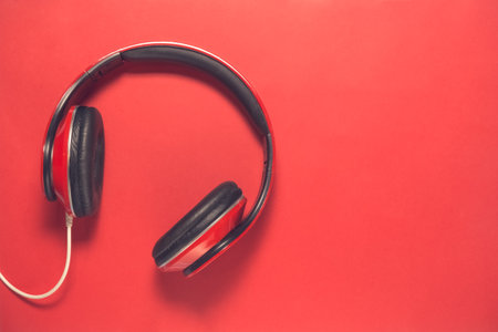 Red headphones isolated on red background flat layの写真素材
