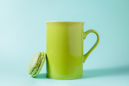 Side view of green macaron and cup. Minimal conceptの写真素材