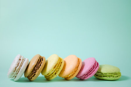 Sweet and colourful french macaroons or macaron on green backgroundの写真素材
