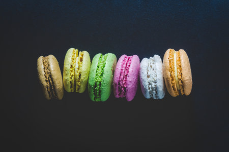 High detailed colorful macarons on black background minimal conceptの写真素材