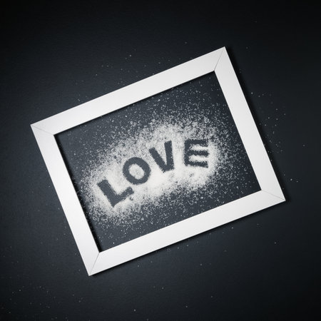 Flat lay of word love written in white sugar framed on black background minimal conceptの写真素材