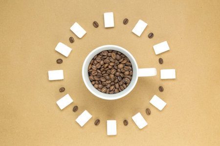 Cup of coffee with coffee beans and sugar cubes around it. Minimal background concept.の写真素材