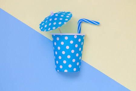 Tropical drink minimal creative summer flat lay concept made of paper polka design cup, paper...
