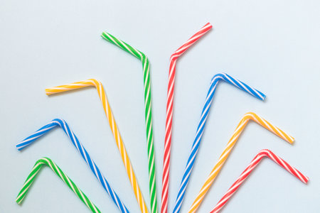 Colorful drinking straws against pastel blue background minimal party creative concept.の写真素材