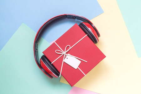 Gift box with headphones on colorful pastel background minimal music creative concept.の写真素材