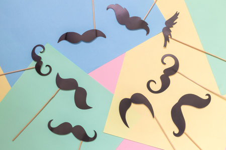 Set of fake mustaches on colorful pastel background minimal creative concept.の写真素材