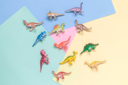 Collection of dinosaurs toys on colorful pastel background minimal creative concept.の写真素材