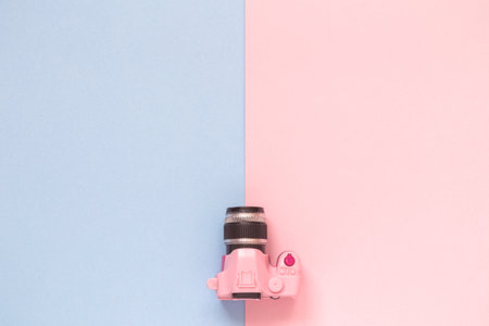 Flat lay of dslr toy model camera on pastel background minimal creative concept. Space for copy.の写真素材