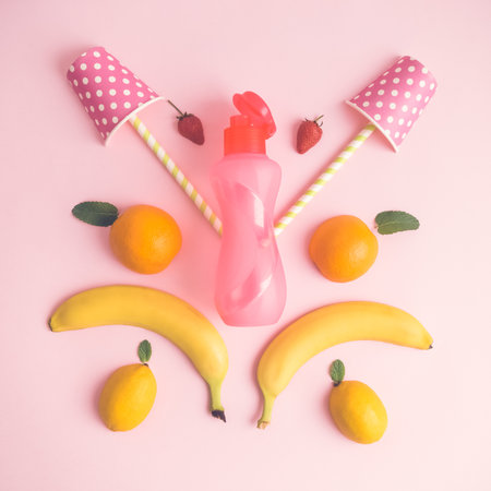 Tropical creative concept made of fruits, paper cups and bottle.の写真素材