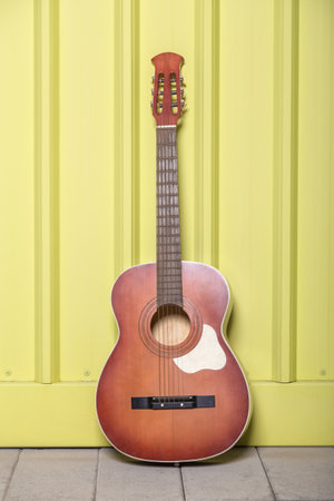 Acoustic guitar on yellow background.の写真素材