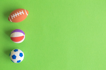 Flat lay of sport balls toys on pastel green background minimal creative concept. Space for copy.の写真素材