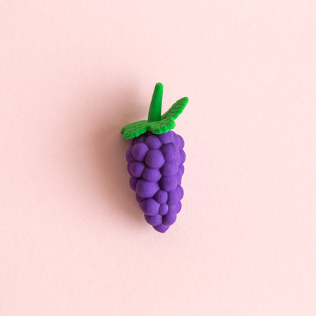 Flat lay of grapes fruit toy on pastel pink background minimal creative concept.の写真素材