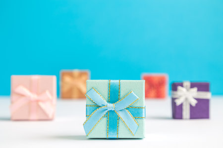 Colorful gift boxes on pastel blue background minimal christmas holiday creative concept.