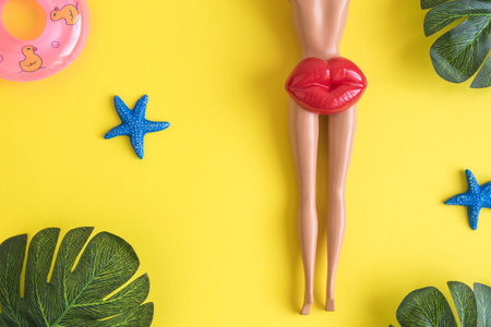 Flat lay of summer travel vacation symbols against yellow background minimal creative concept.の写真素材