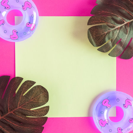 Summer background of monstera tropical leaves and inflatable floats minimal creative concept. Space for copy.の写真素材