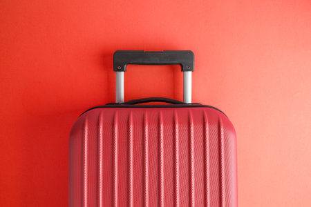 Suitcase on red background minimal creative travel concept.の写真素材
