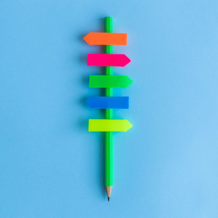Flat lay of directions sign made of pencil and colorful blank sticky notes against pastel blue...