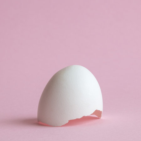 Egg shell against pastel pink background minimal creative easter concept.の写真素材