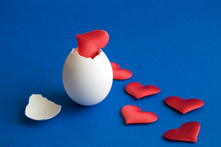 Hearts coming out of egg shell minimal creative easter and love concept.の写真素材