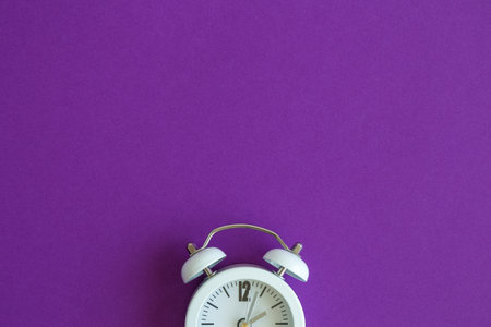 White clock on purple background. Space for copy. Minimal concept.の写真素材
