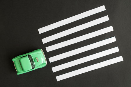 Overhead view of small car and pedestrian pathway on a street crossing abstract.の写真素材
